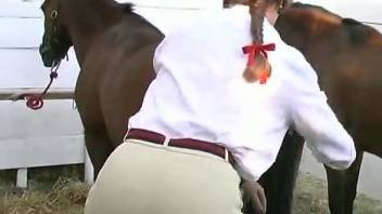 Athletic jockey in black helmet gets pounded by her own stallion